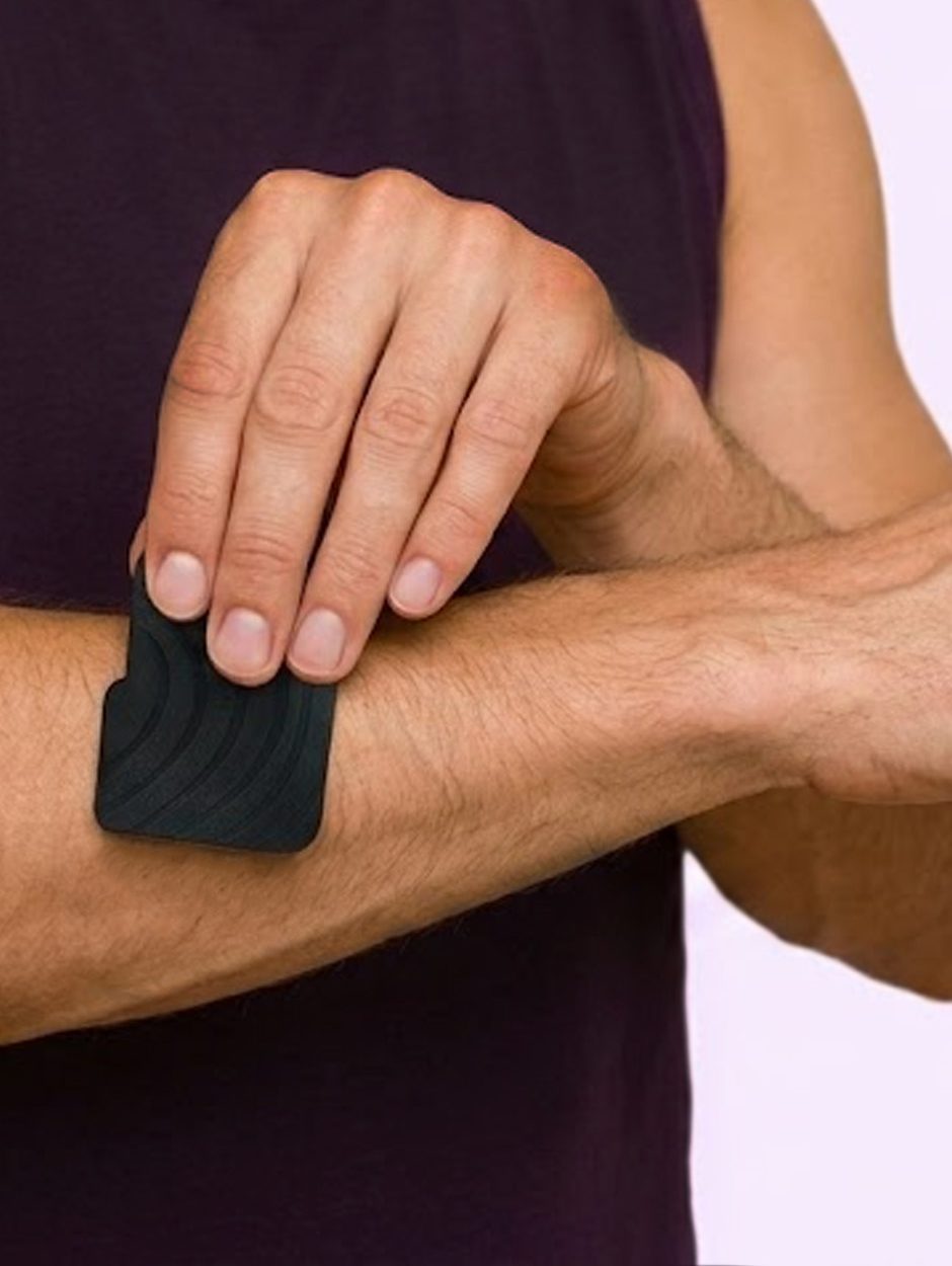 A man peeling a Steelhaus strip off his forearm